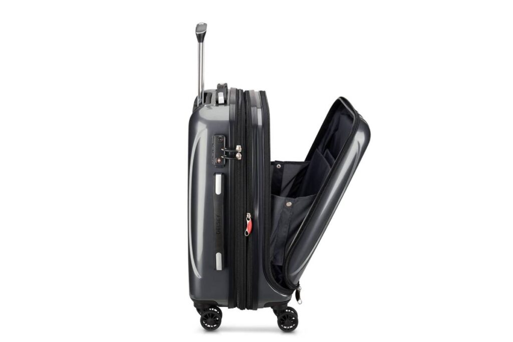 A gray hard-shell suitcase with wheels, partially opened to reveal a spacious interior and multiple compartments.