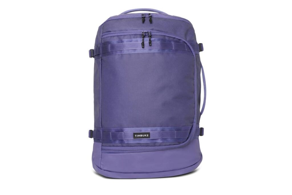 A purple Timbuk2 backpack featuring multiple zippers and adjustable straps, designed for stylish and functional travel.