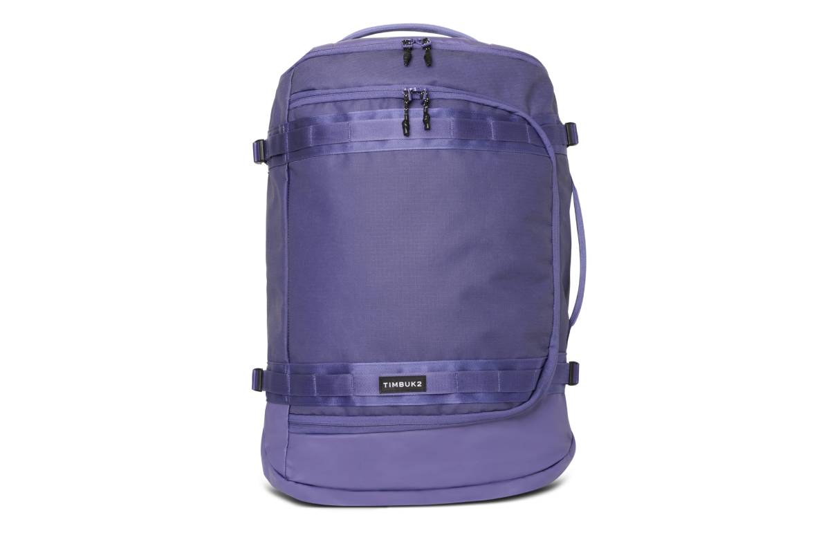 A purple Timbuk2 backpack featuring multiple zippers and adjustable straps, designed for stylish and functional travel.