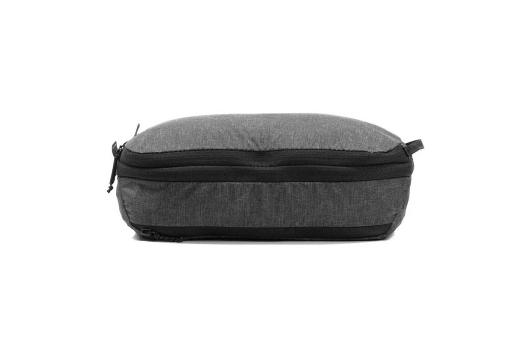 A sleek, dark gray zippered pouch with a rounded top and a flat base, perfect for organizing small items.