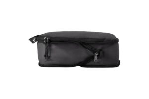A sleek black packing cube with zippers and a top handle, designed for organized travel and efficient storage.