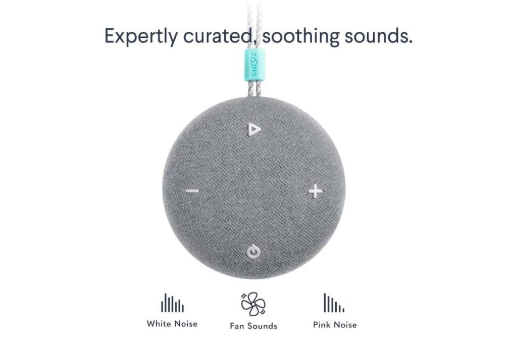 A round gray sound machine with buttons for white, pink, and fan noises, promoting soothing, curated sound experiences.