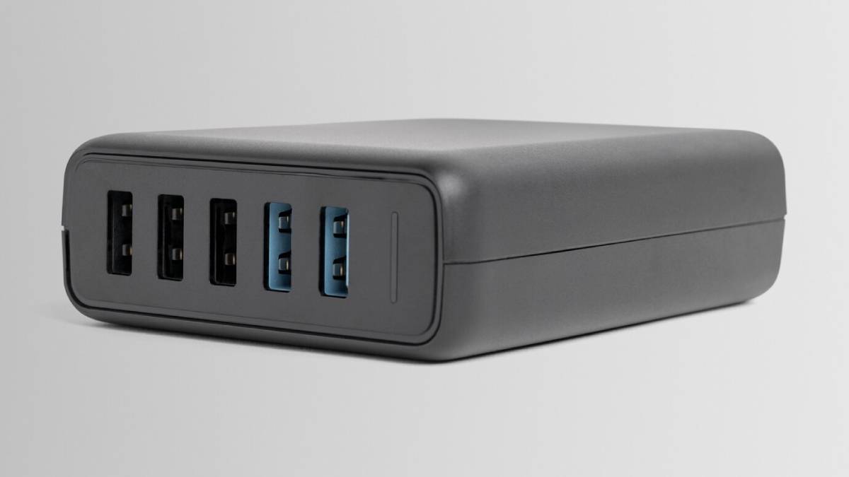 A compact black USB hub with four black USB ports and two blue USB 3.0 ports on the front, designed for connectivity and charging. 